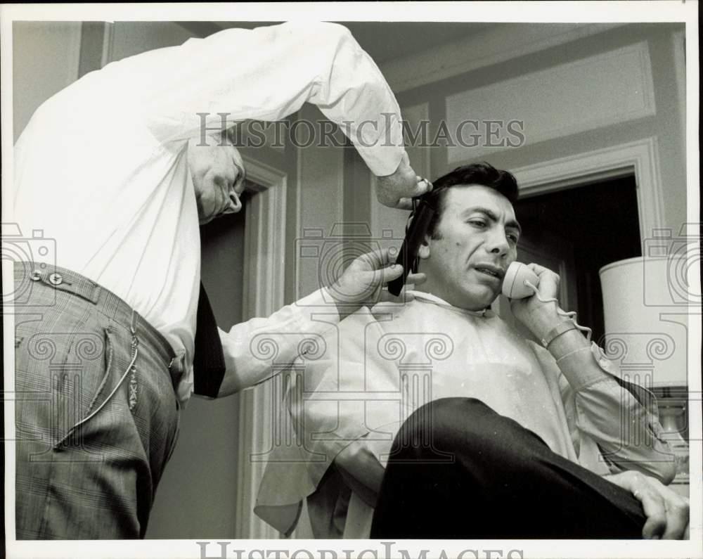 1967 Press Photo Ed Ames gets haircut while talking on the phone - kfa27938