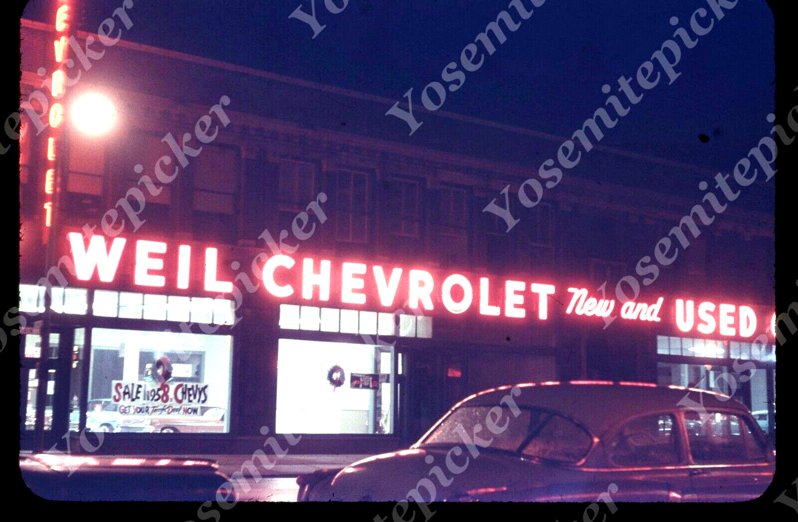 sl84 Original slide 1957 Chevrolet Dealer night view cars 690a
