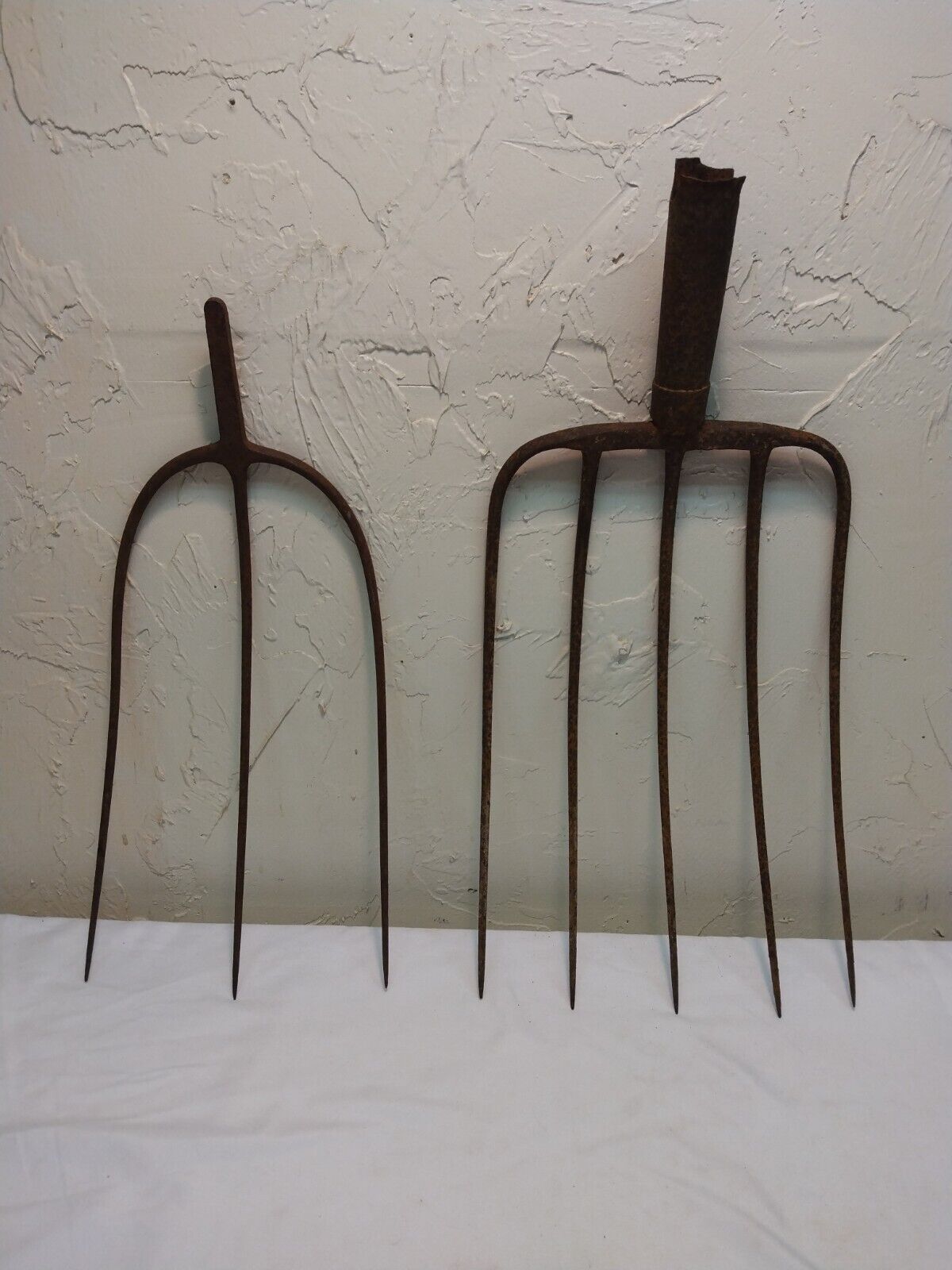 two antique cast iron pitchforks