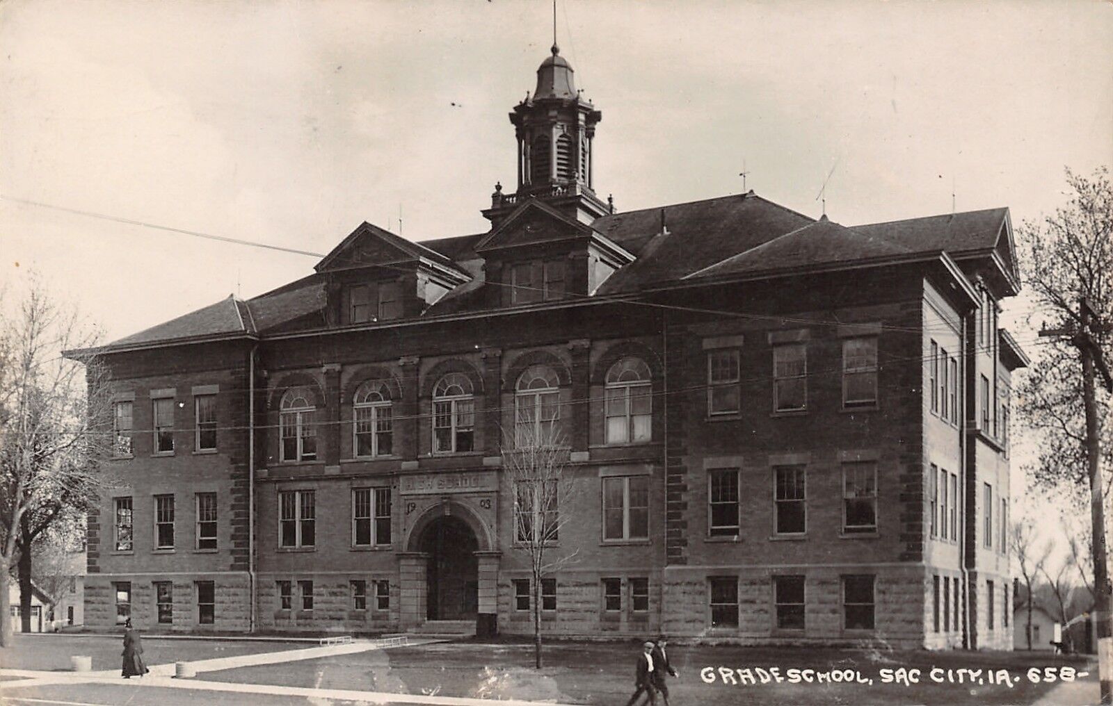 Sac City Iowa~Lady in Black in Front of School (Built in 1903) RPPC 1930
