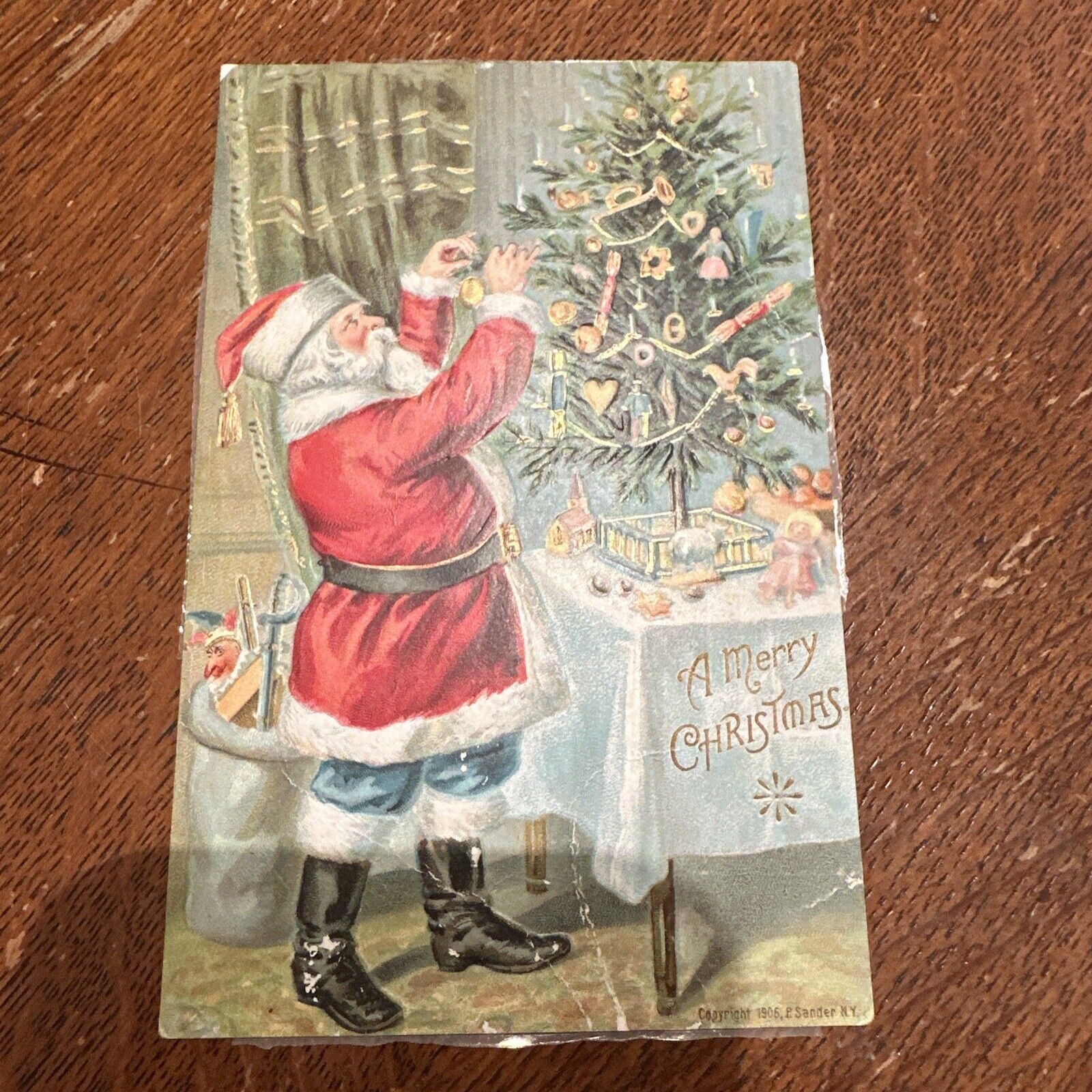 1905 A Merry Christmas Santa Clause Trimming Tree Embossed Toys Postcard