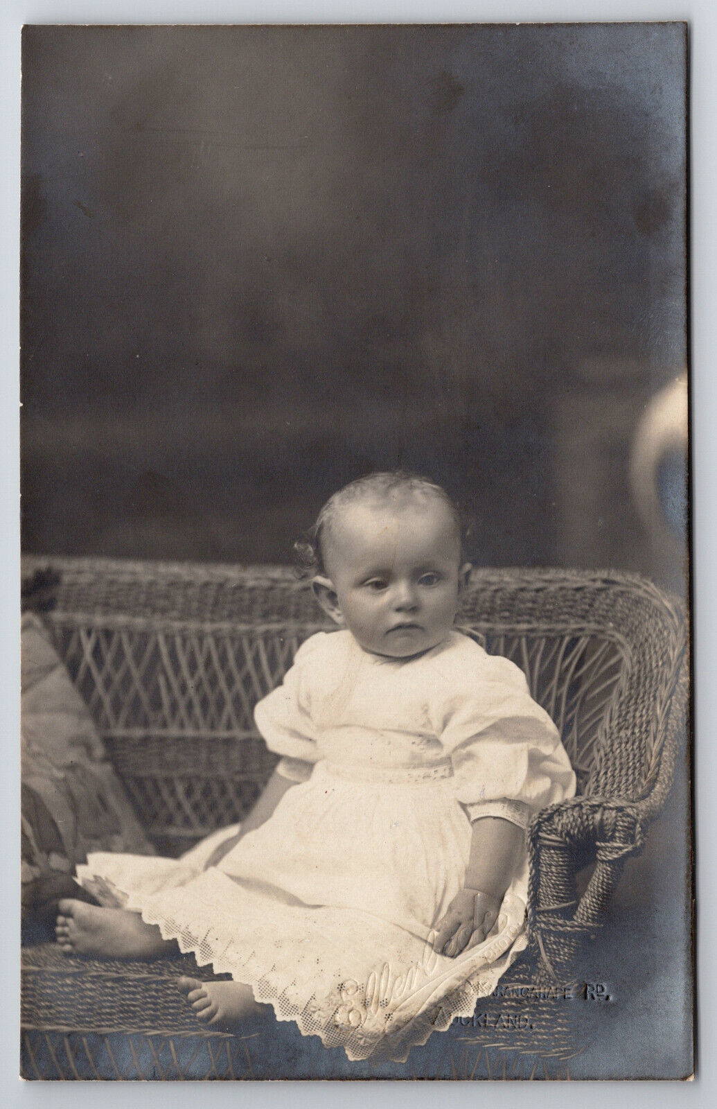 Vintage C1905 RPPC Postcard Baby Posing On A Wicker Chair
