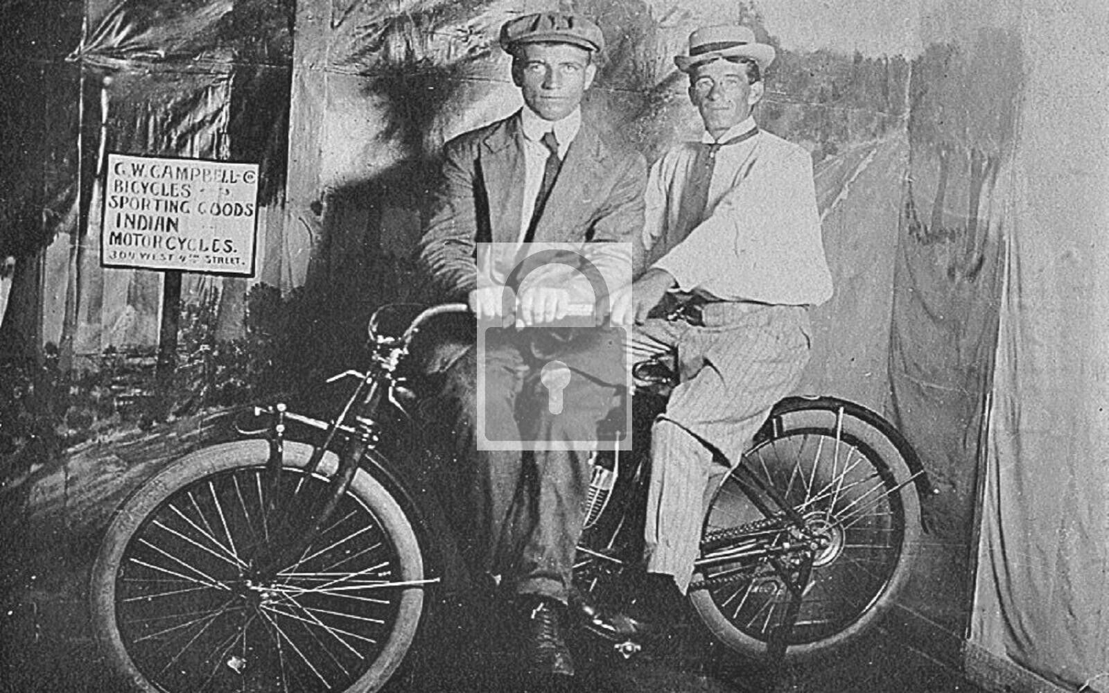Two Men Sitting On Vintage Indian Motorcycle Reprint Postcard