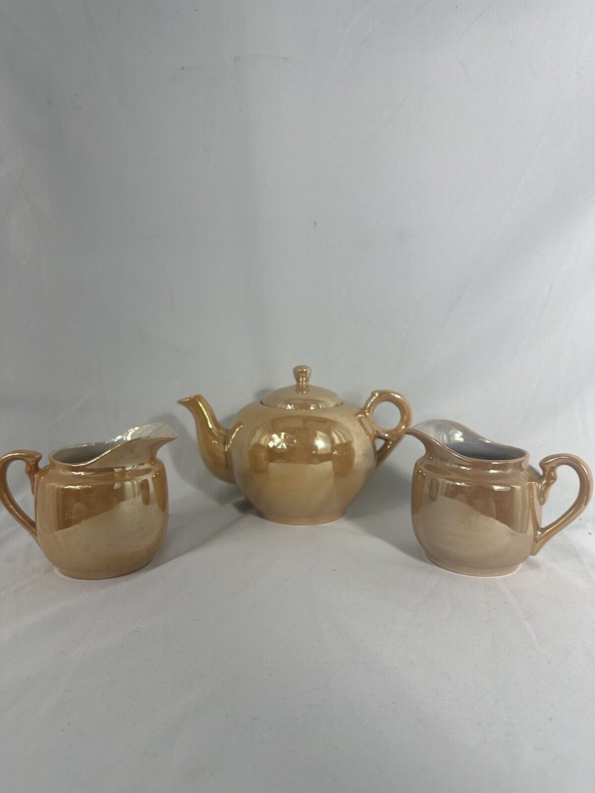Peach lustre tea pot and 2 creamer ,  Japan 5” W 5” H (Pot)  3.5”/3.5” Creamer