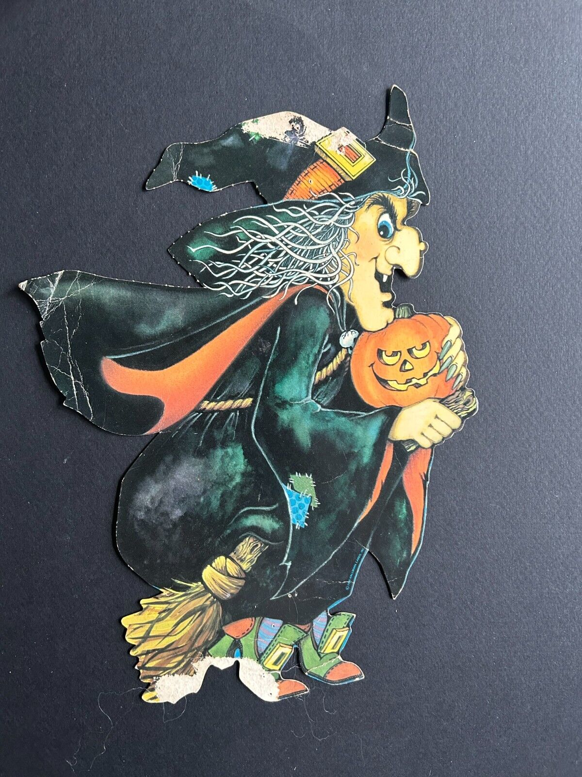 Vintage Halloween Decoration: Witch on a Broom Holding a Jack-o-Latern