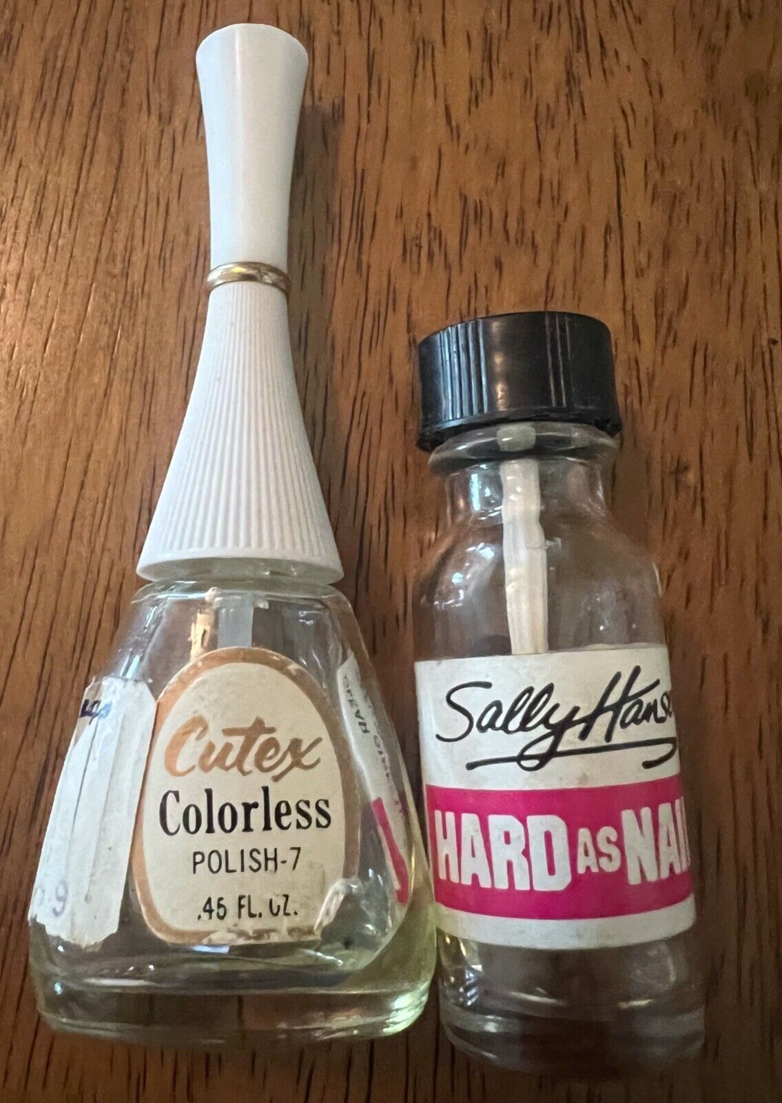 Two vintage bottles of clear fingernail polish. Cutex and hard as nails.