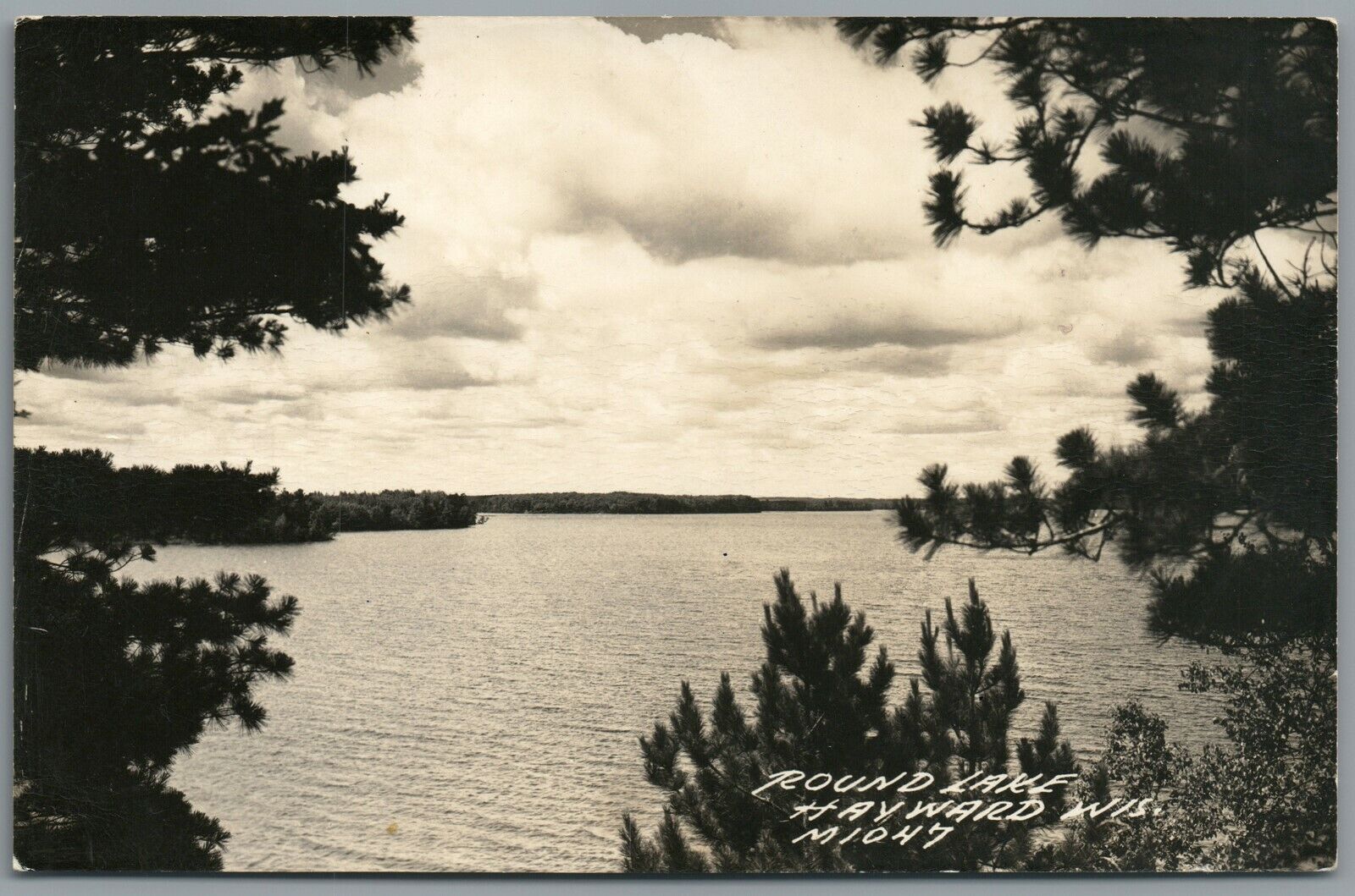 RPPC Postcard Hayward WI Round Lake seen through the trees circa 1939-1950