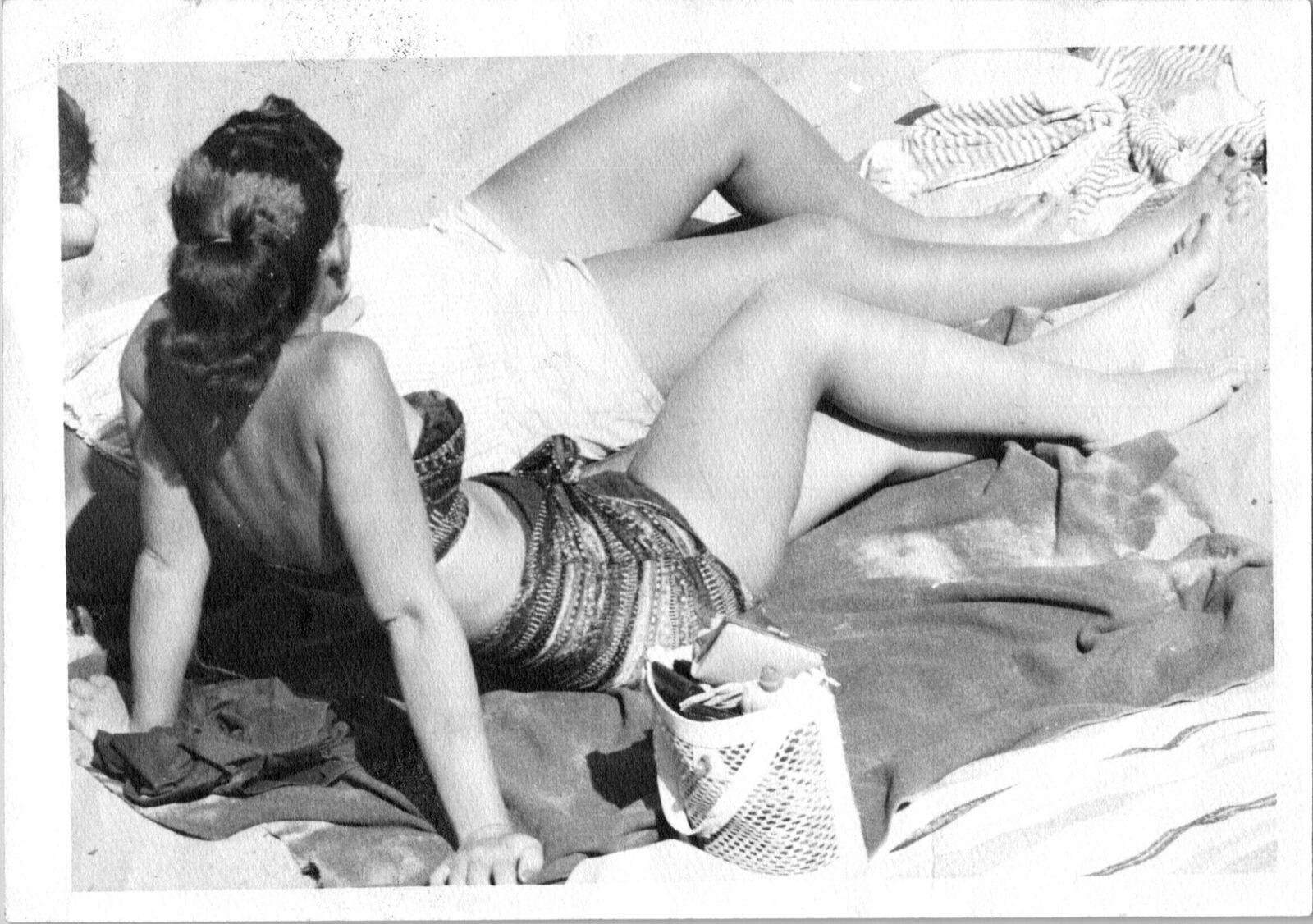 Pretty women in bathing suits at beach sunbathing Found Photo V0492