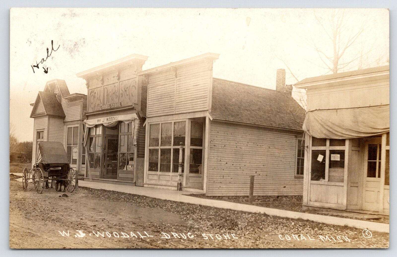 Coral MI Woodall Drug Store (Great Wood Sign)~Frank Playing For Dance 1912 RPPC