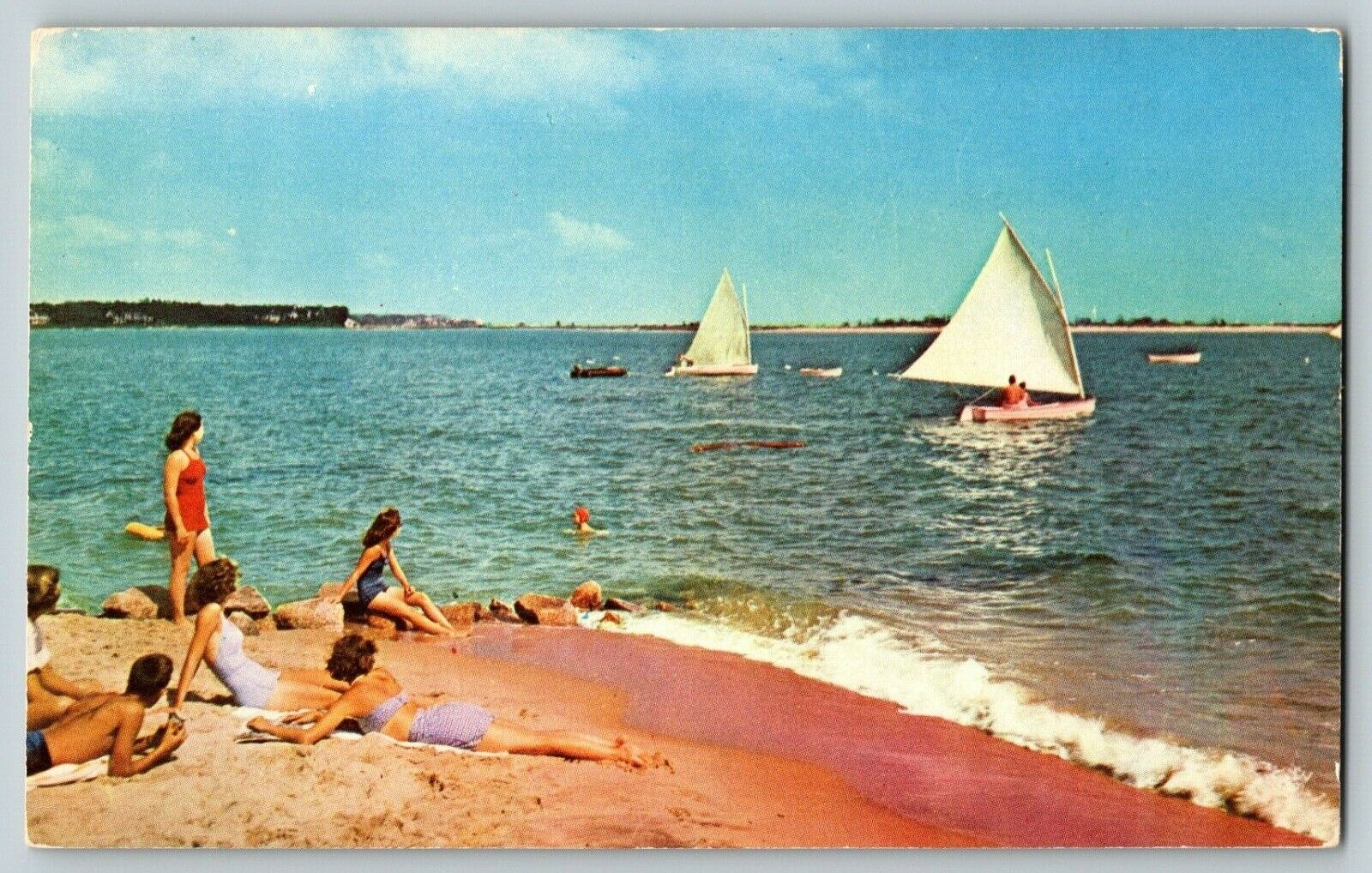 Postcard Sailboats Sailing next to Beach Sunbathers Greetings from Pensacola FL