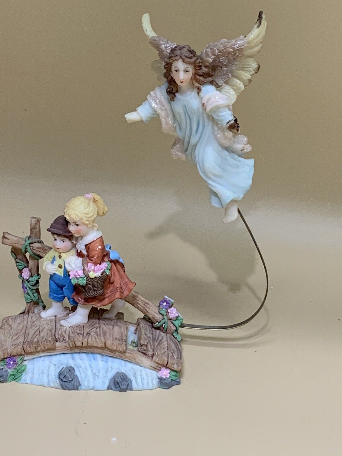 CUTE FIGURINE WITH TWO CHILDREN WITH AN ANGEL ABOVE