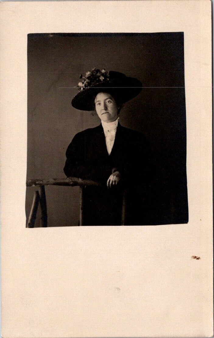 RPPC Woman Fancy Hat With Flowers Leaning On Prop c1910-20s photo postcard HQ8