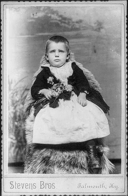 Photo:Harrison Morton Marquardt,Small child,holding flowers