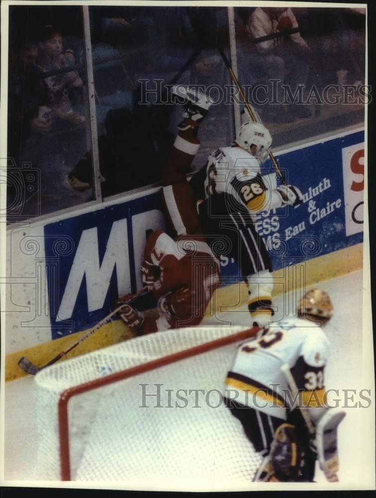 1992 Press Photo University of Wisconsin Hockey player gets knocked down, Duluth