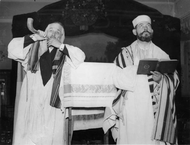Yom-Kippur-celebration A rabbi asks with his shofar the congregati- Old Photo