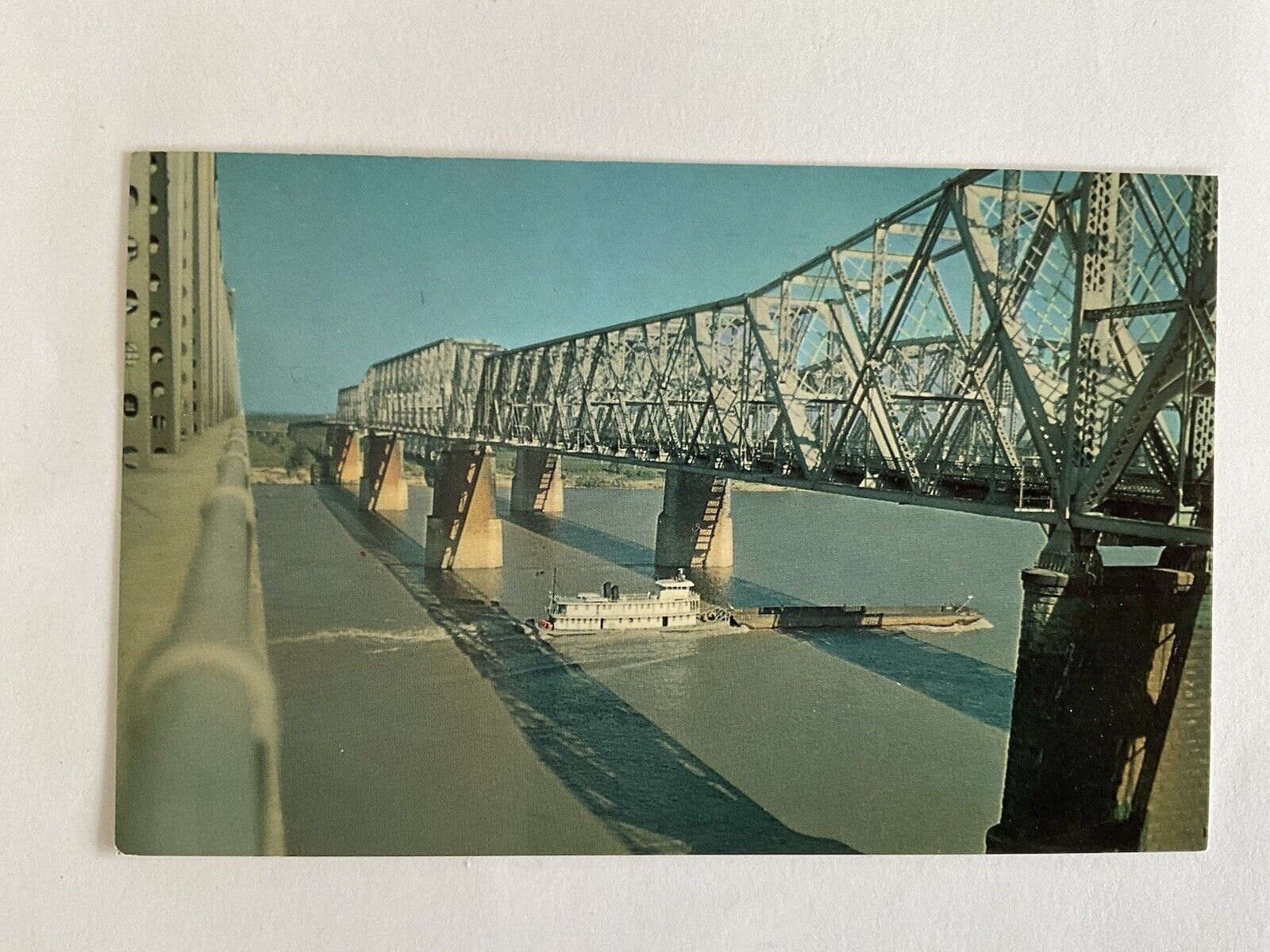 Tennessee~Memphis-Arkansas bridge~through truss~barge~tugboat~Mississippi River