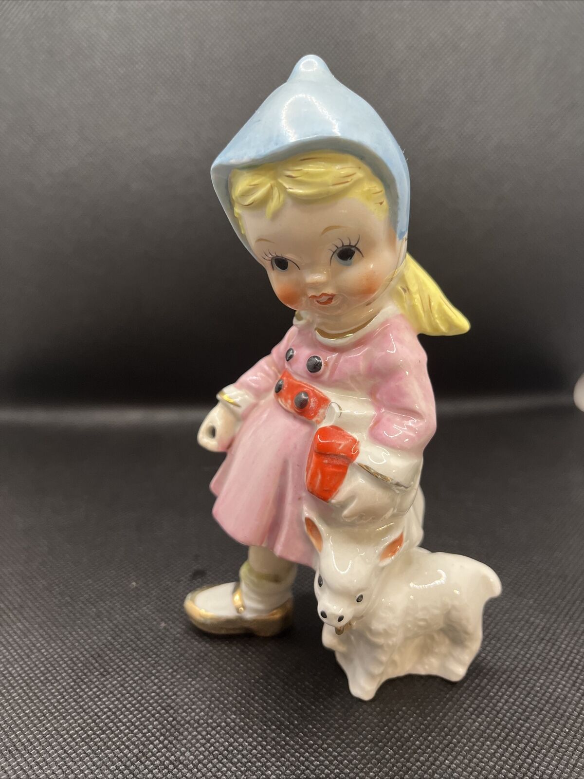vintage girl with lamb figurine