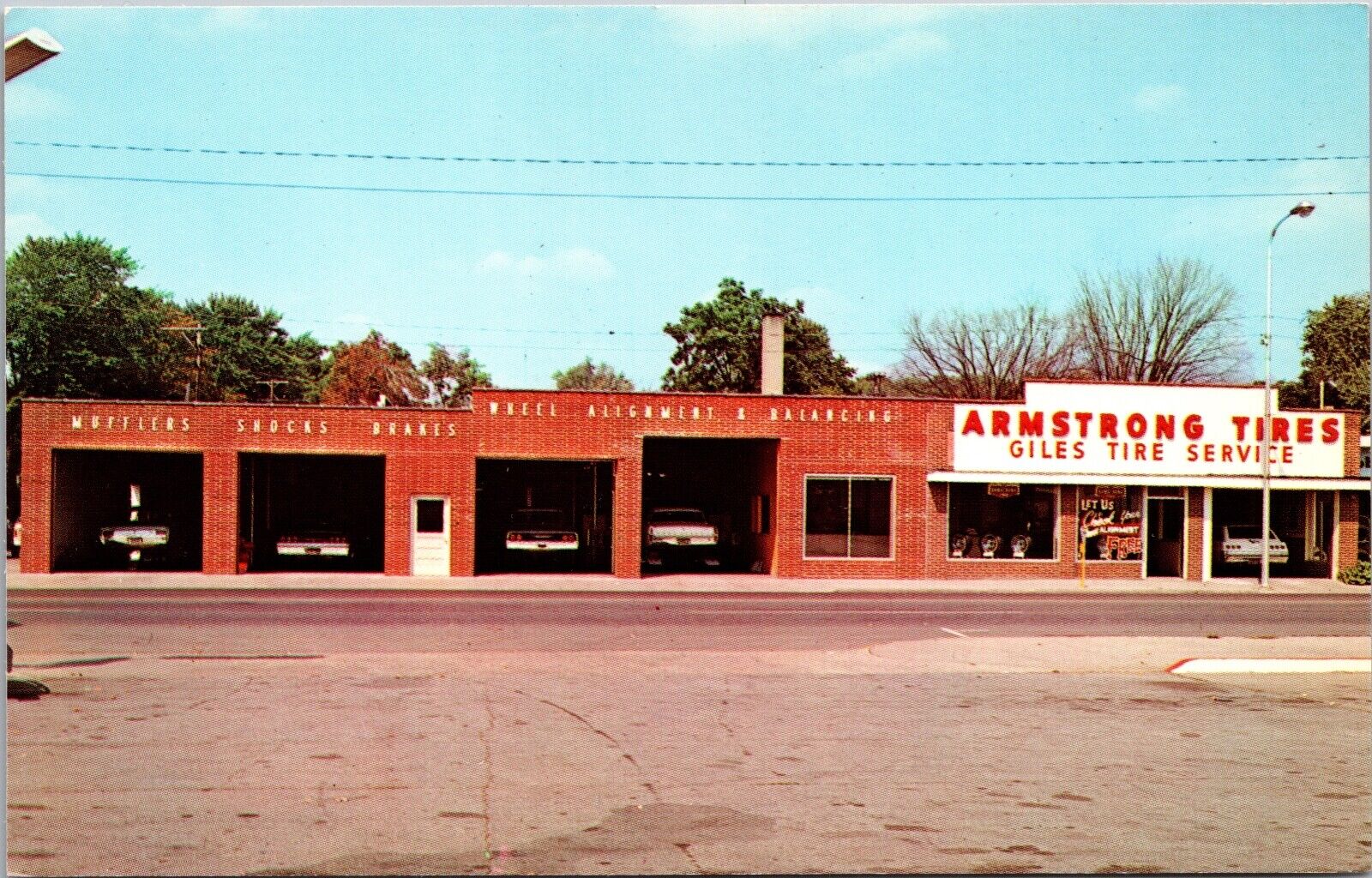 Postcard Armstrong Tires Giles Tire Service in Alma, Michigan