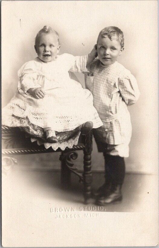 1910s JACKSON Michigan Studio RPPC Photo Postcard Baby Pulling at Brother's Ear