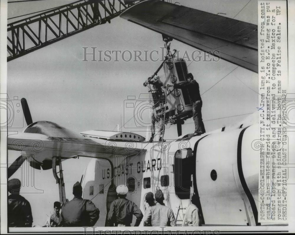 1962 Press Photo Elizabeth City NJ Iron lung is hoisted from COast Guard plane.