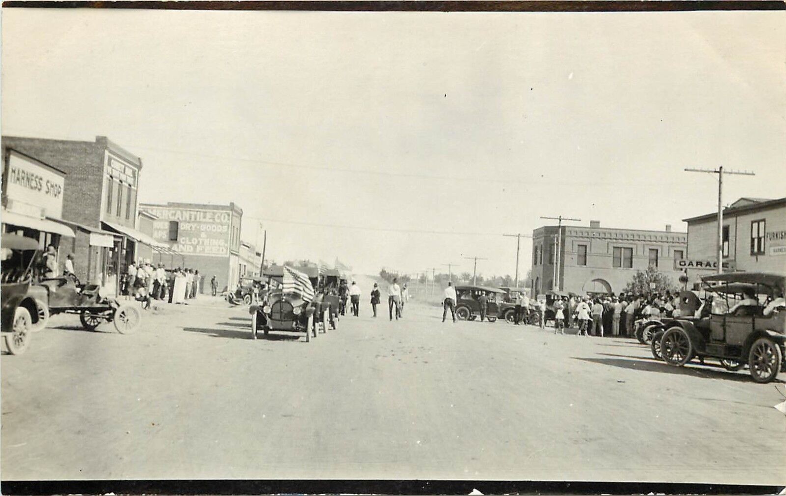 c1910s RPPC Postcard Deerfield KS Main Street Automobile Parade Kearny County
