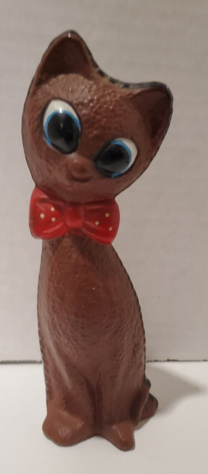 VTG Ceramic brown cat with painted black stitching and a red bow. Big Eyes