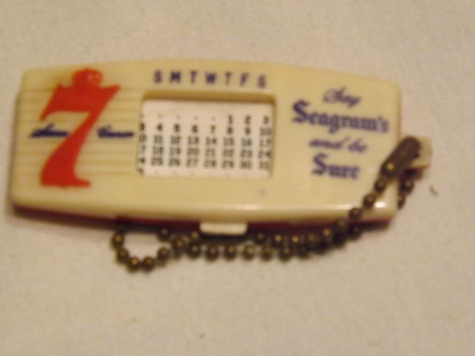 Rare Plastic Say Seagram\'s 7 and be Sure Calendar Keychain