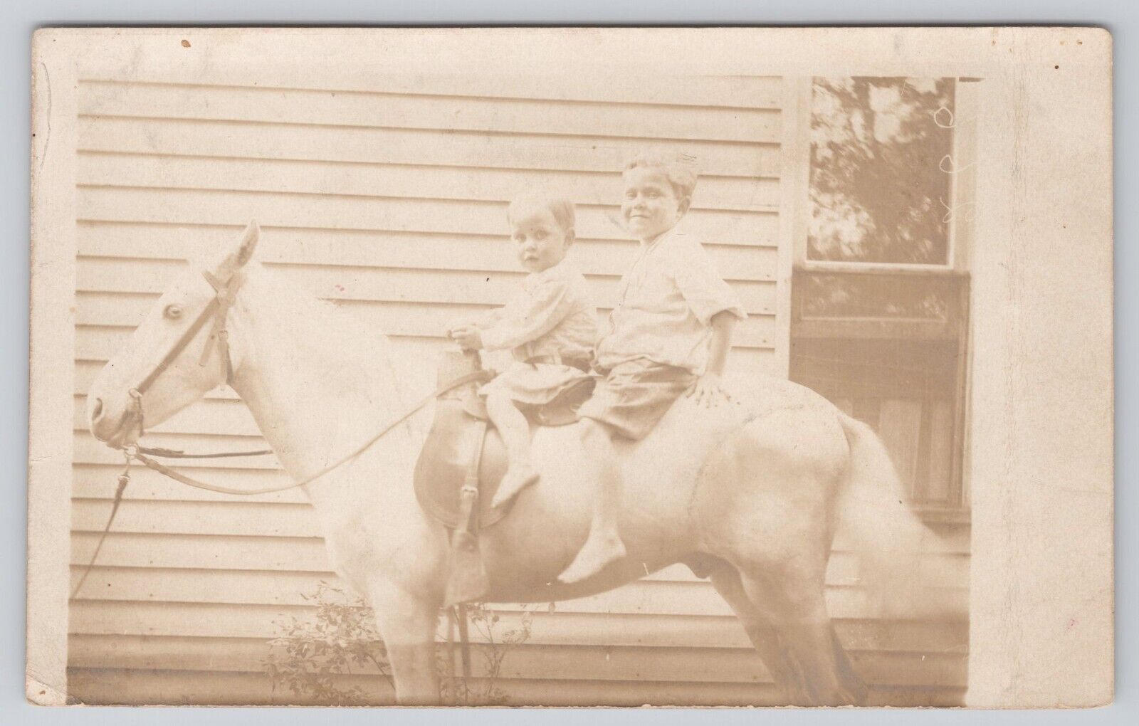 Two Young Children Sitting on White Horse Beside House c1904-1920s RPPC Postcard