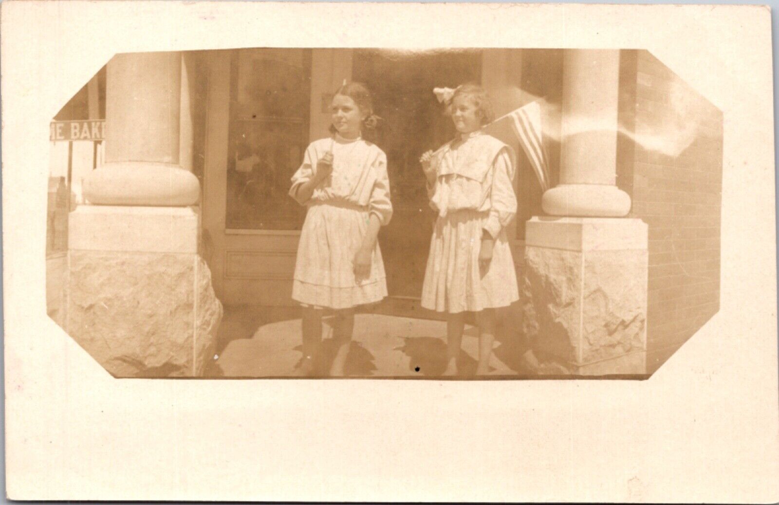 Real Photo Postcard Two Girls on a Front Porch Holding American Flags