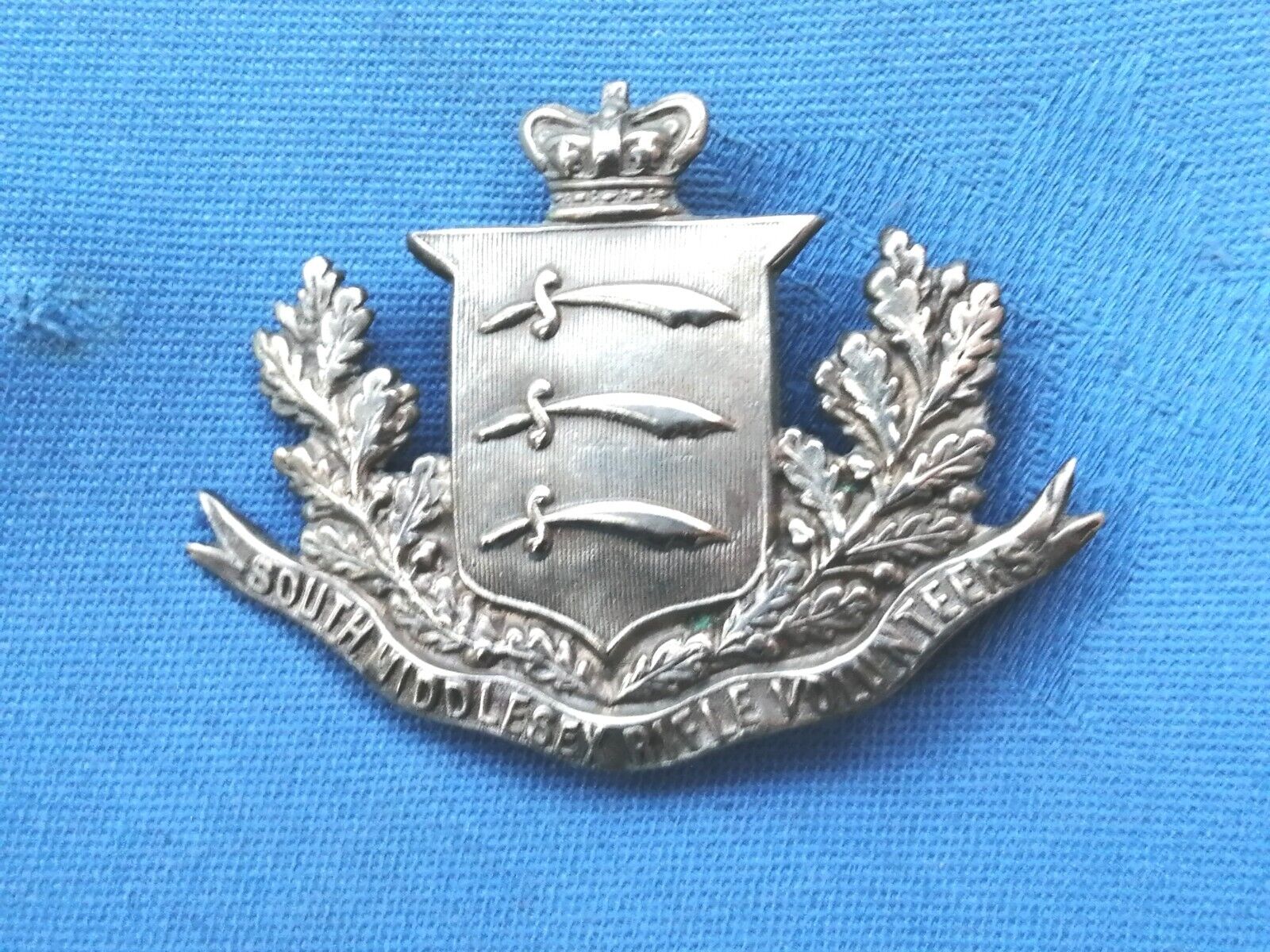 The South Middlesex Rifle Volunteer cap badge.