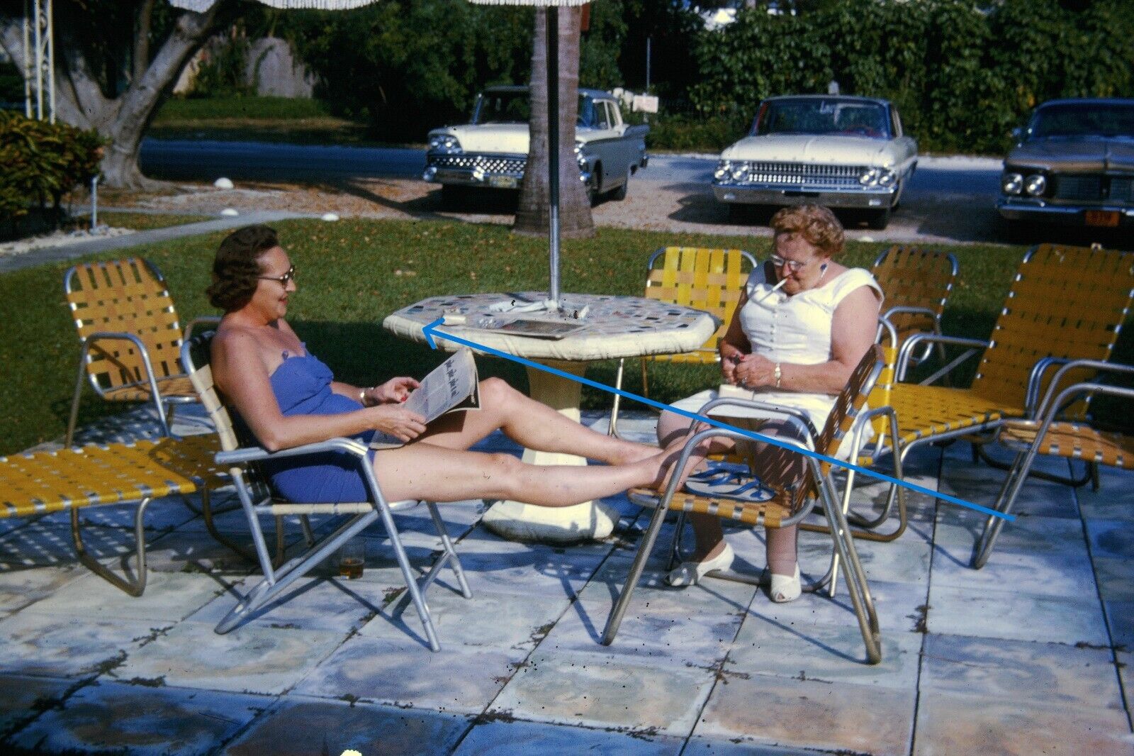 1963 35mm Slide Two Women at Patio Table Smoking Ford Cars Webbed Chairs #1250