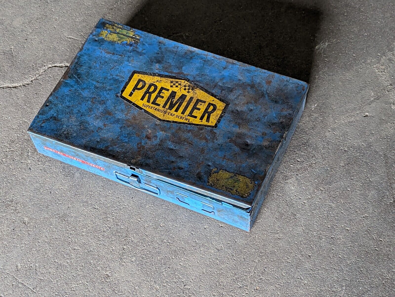 Vintage, distressed Premier Supertanium Cap Screws metal box with contents