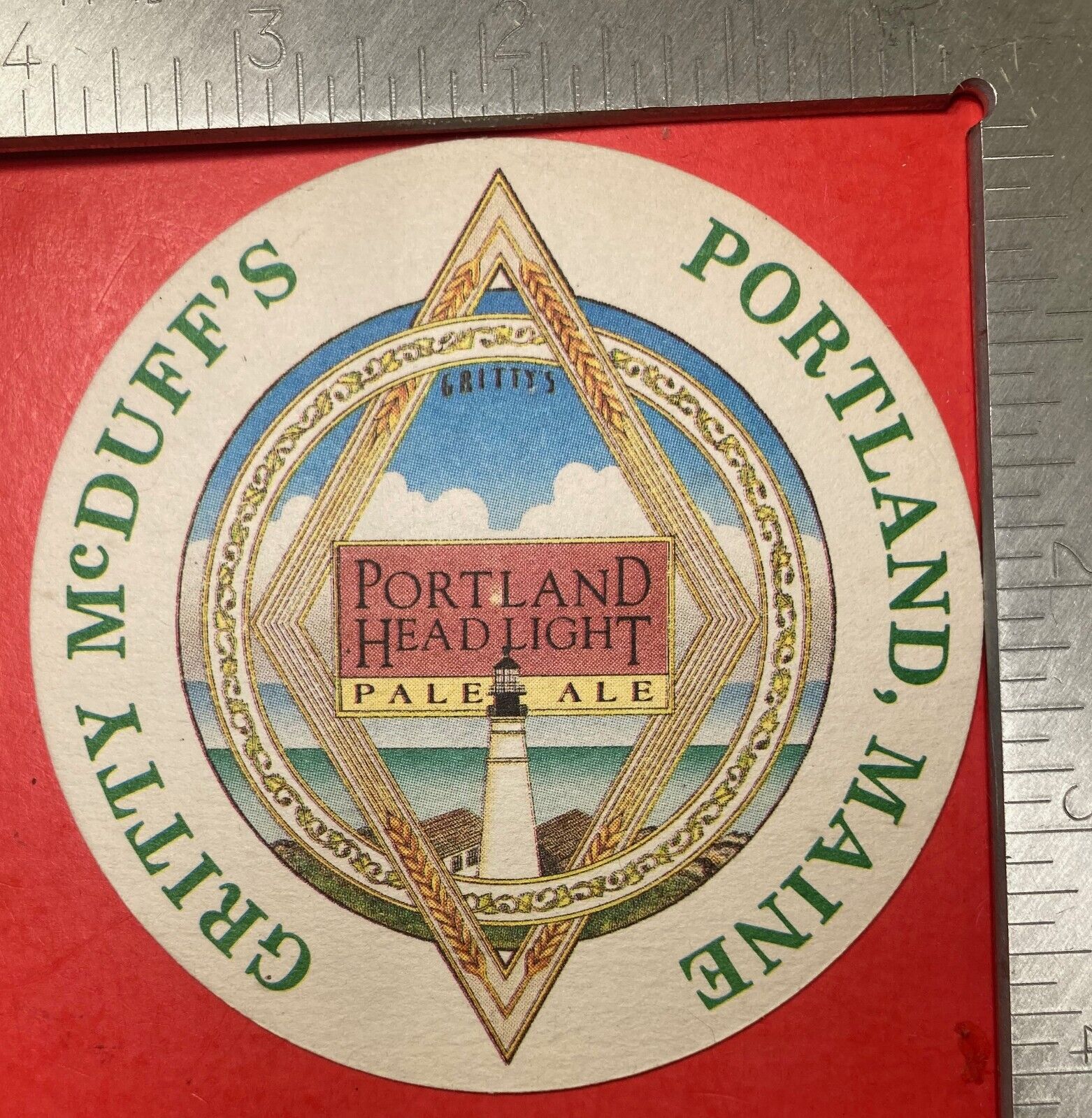 GRITTY McDUFF\'S. PORTLAND,MAINE. 4 INCH ROUND BEER COASTER VINTAGE LIGHTHOUSE