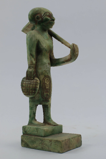 In a perfect scene The Egyptian High priest standing and holding the AXE