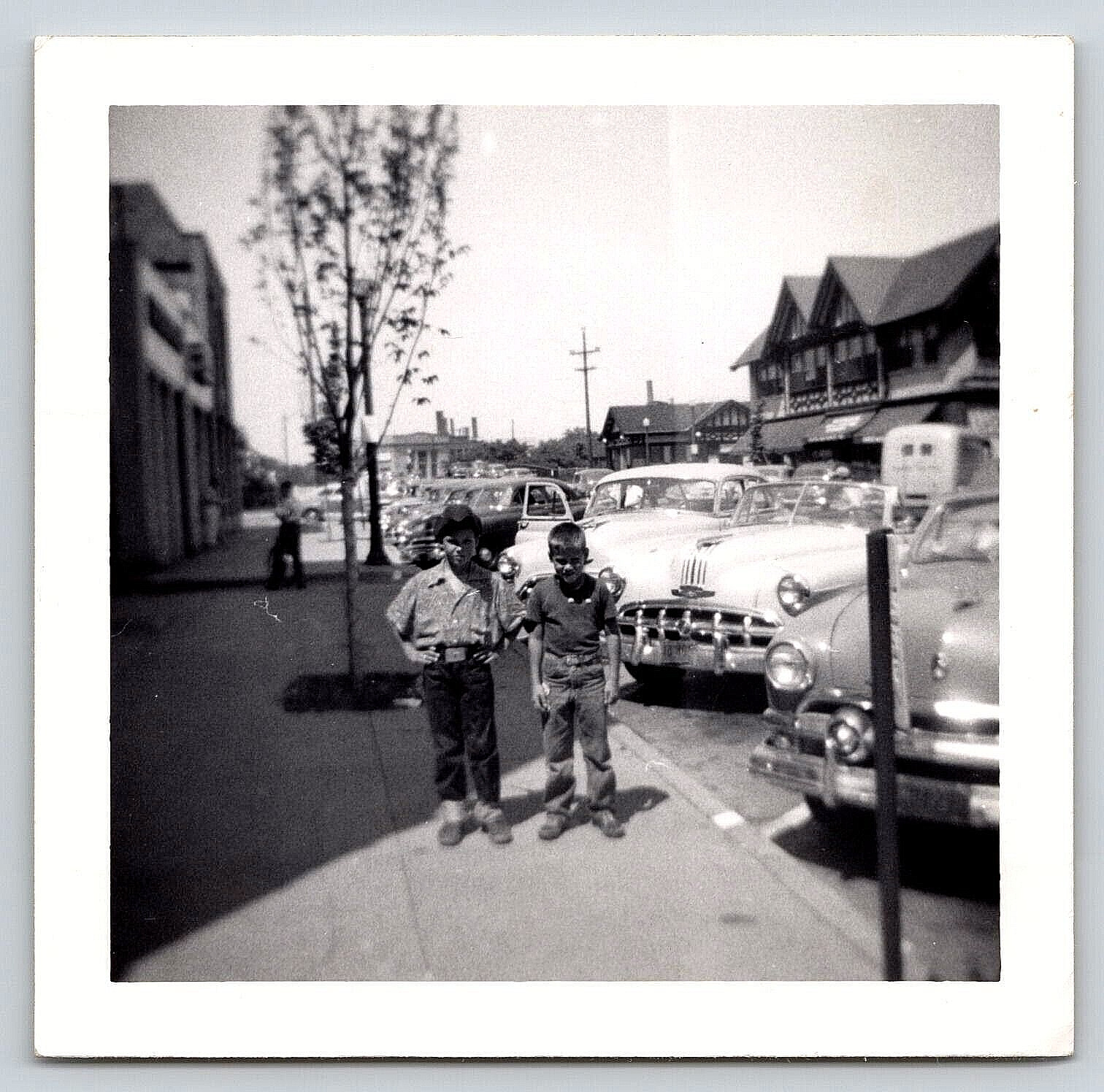 Photograph VTG Automobiles Boys Cars Town Buildings Street View Fashion 1950\'s