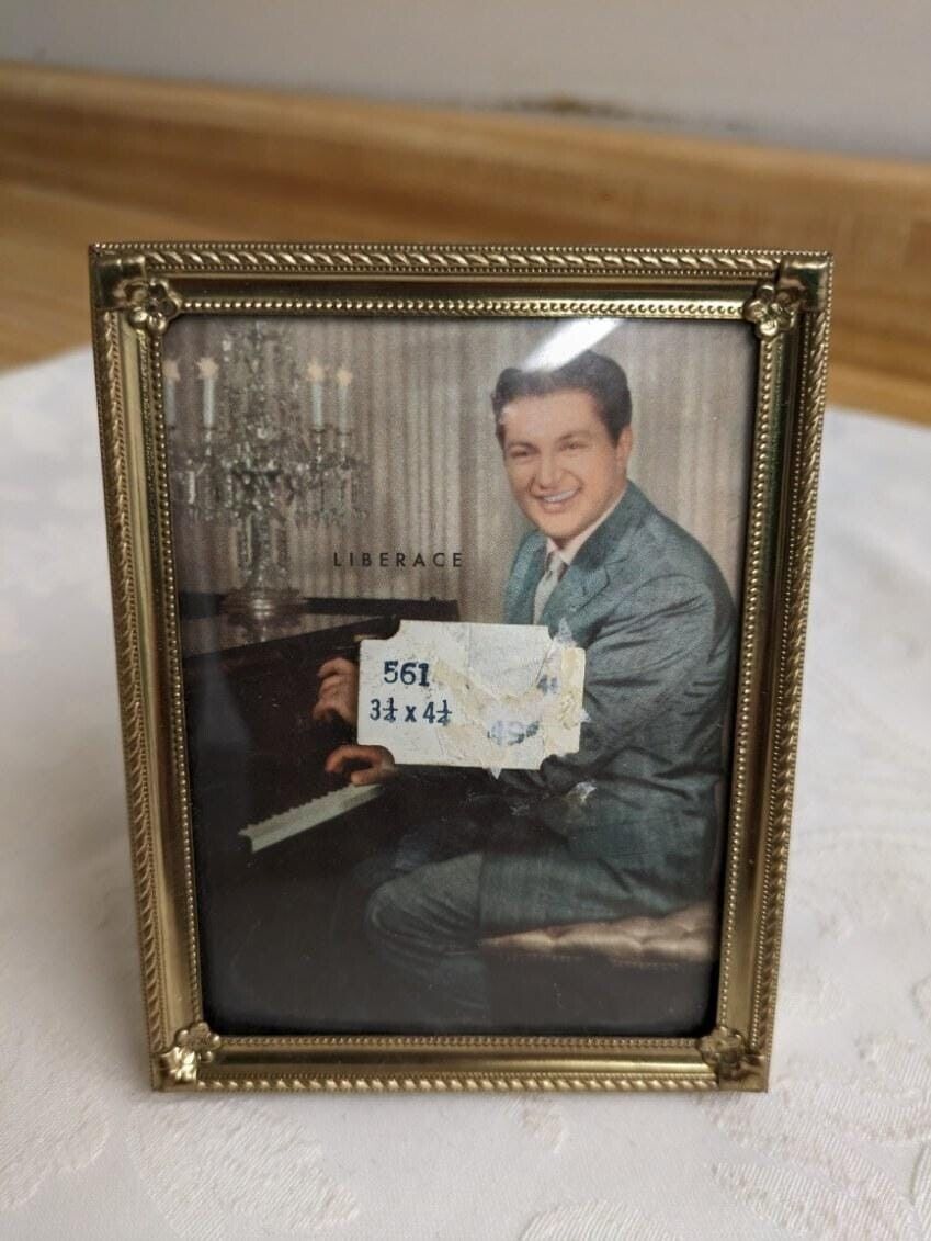 Vtg. Liberace standing picture in photo frame at piano.