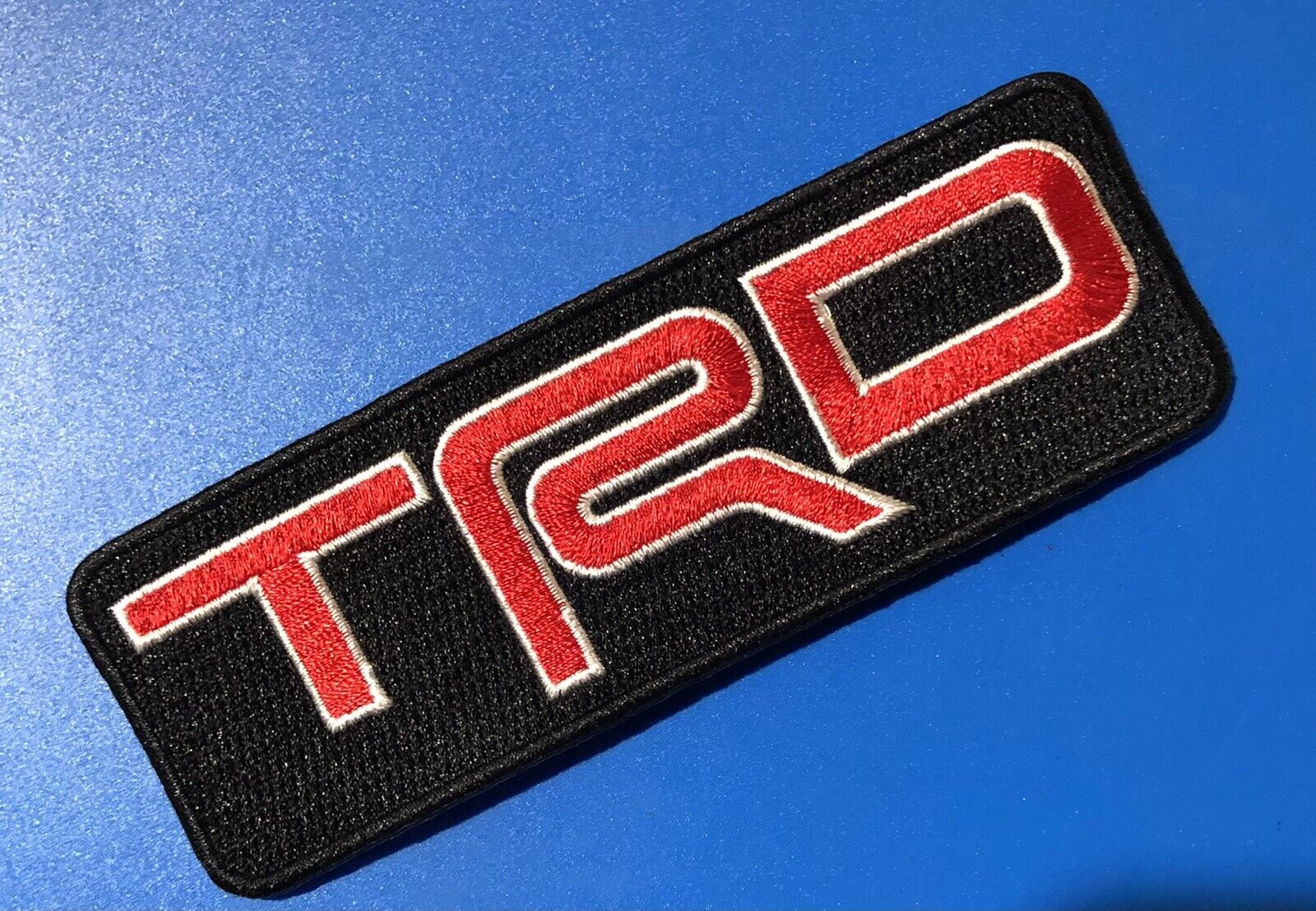 TRD Toyota Racing Development Iron On Patch.       5”x1.75” Red w/ Outline