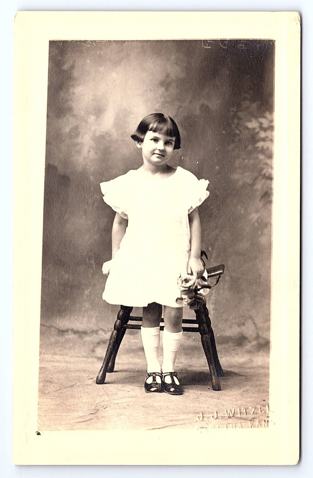 Postcard RPPC Girl w Flower Bouquet in White Dress, Sabetha, Kansas Photographer