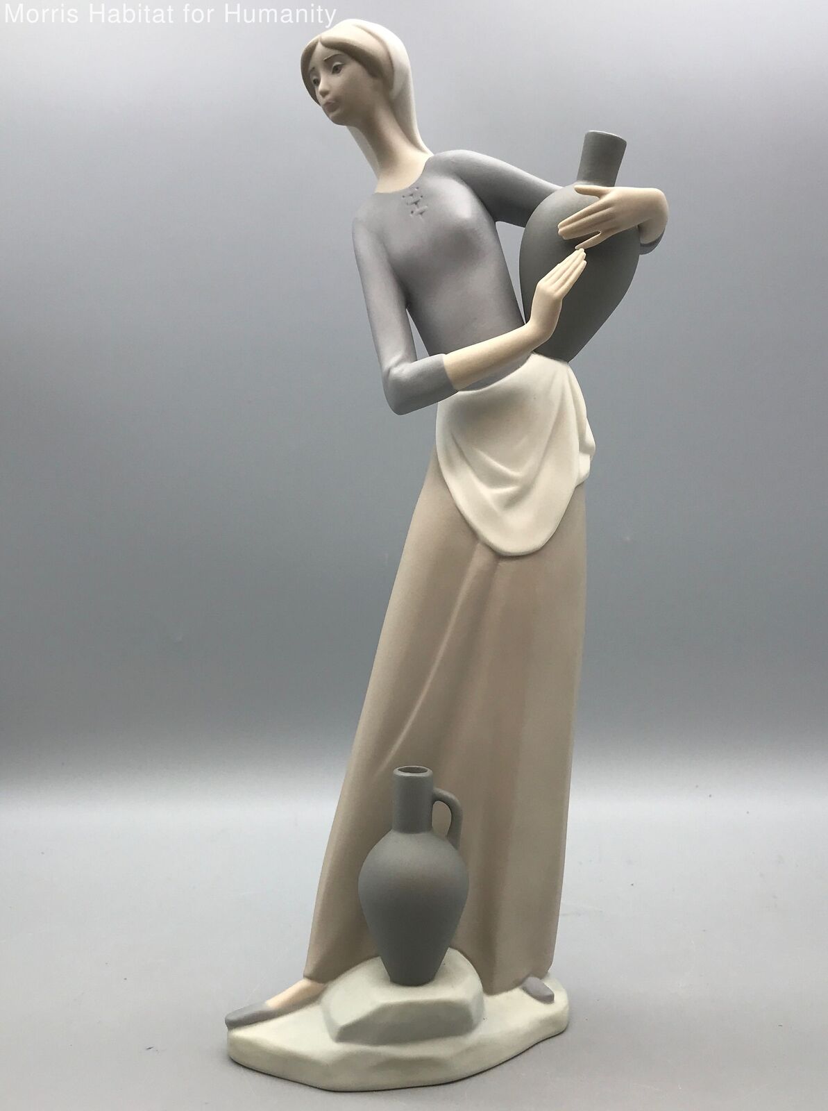Blue/Cream Lladro Woman Figurine. 1985 The Jug Carrier collection. #4875