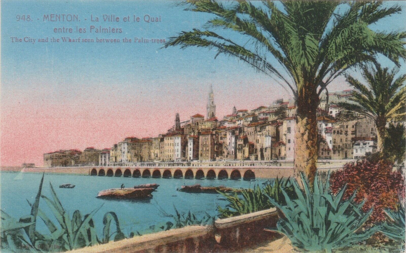 Menton, France. The City of Menton and the Wharf seen between the Palm Trees