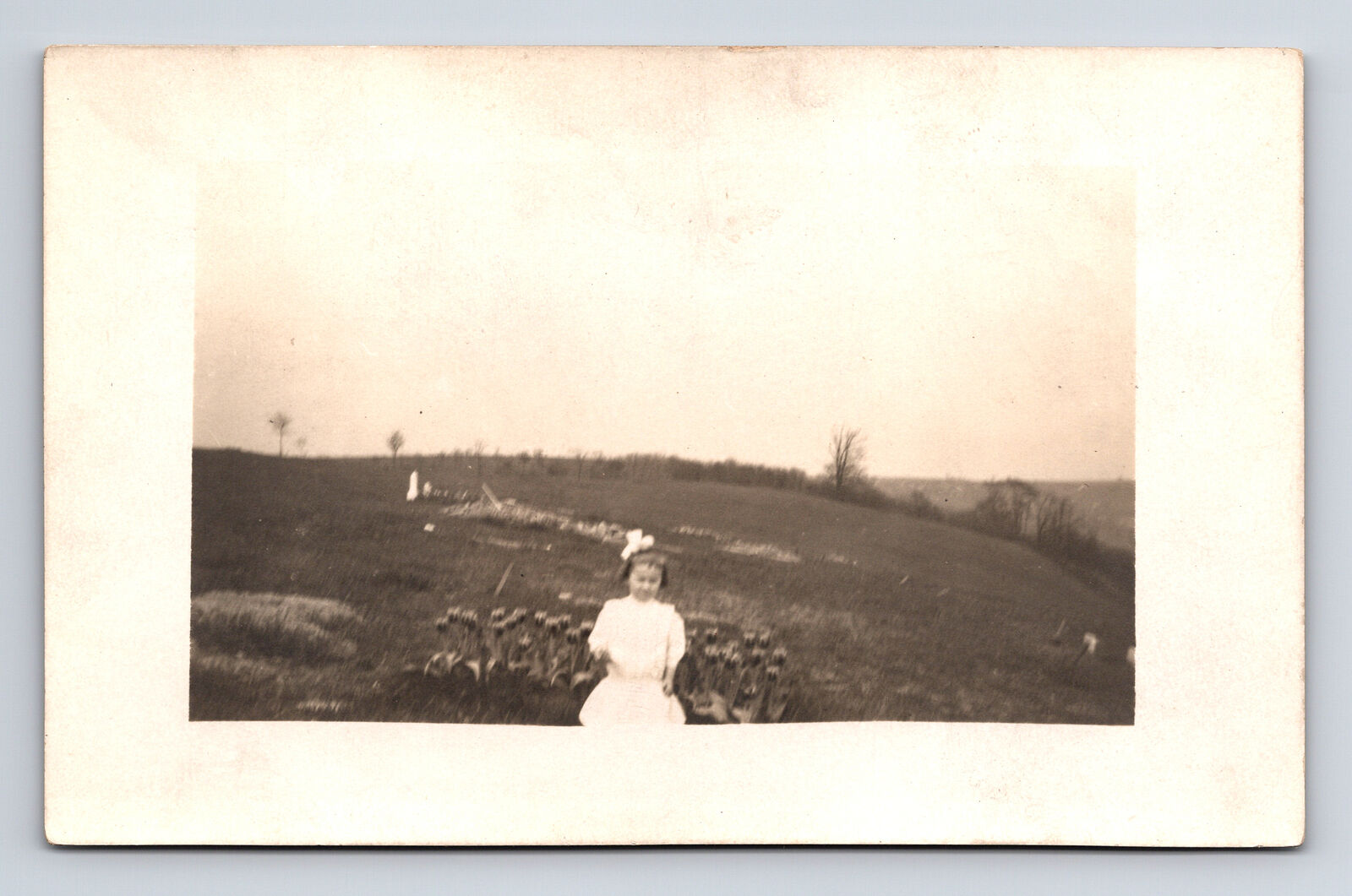 RPPC Dreamy Portait of Young Girl on Hillside Pasture Tulip Flowers Postcard