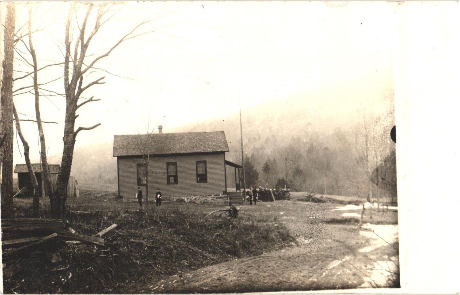 An Old Photograph of Boy Standing By A Small House Postcard