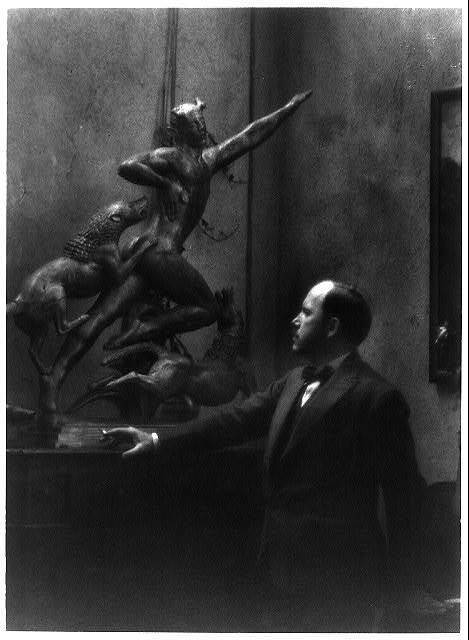 Photo:Paul Howard Manship,1885-1966,American sculptor,looking at statue