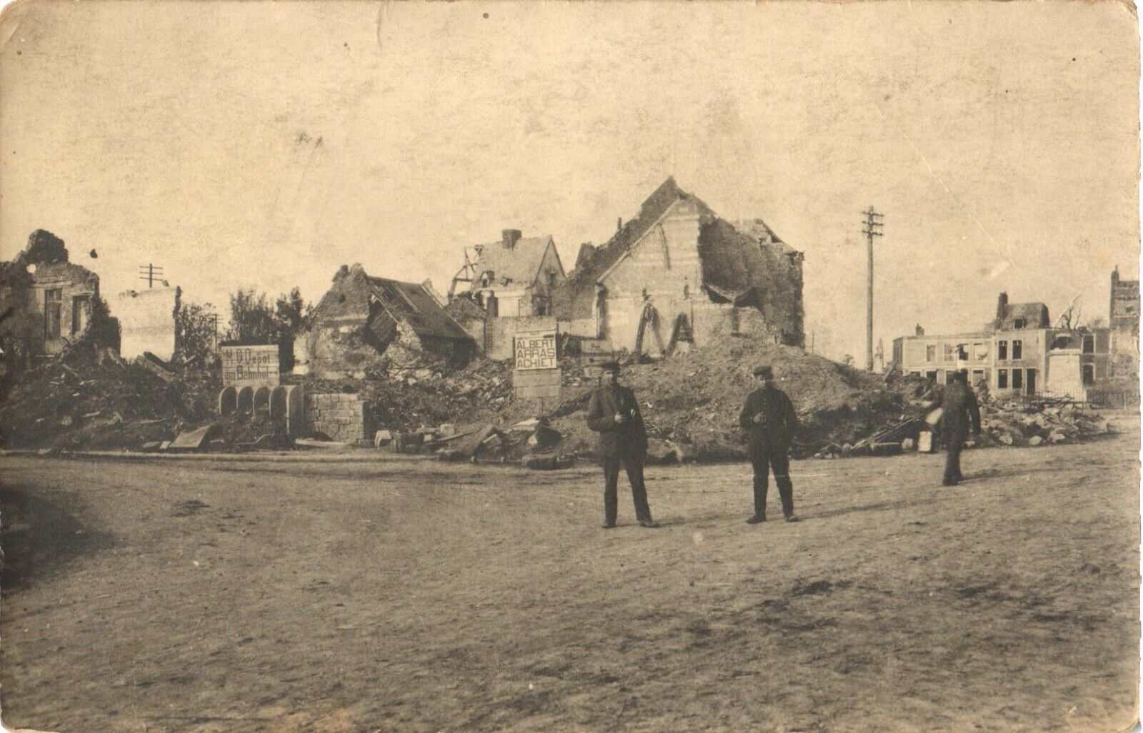 An Old Photo of Men In Uniform Along Ruined Houses Postcard