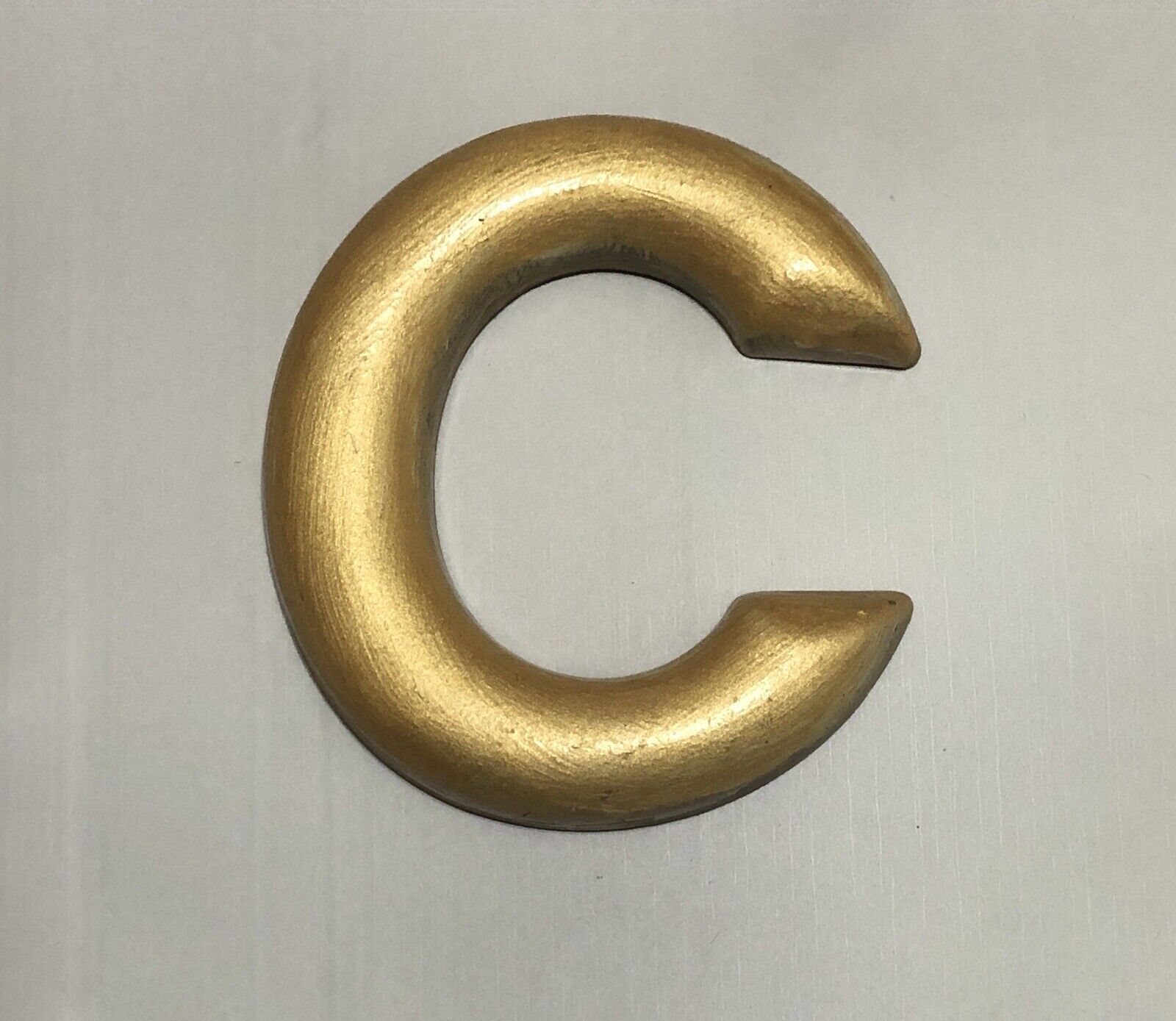 Vintage plastic sign gold letter C