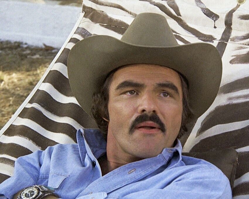 Burt Reynolds relaxing on hammock in blue shirt and cowboy hat 24x30 Poster