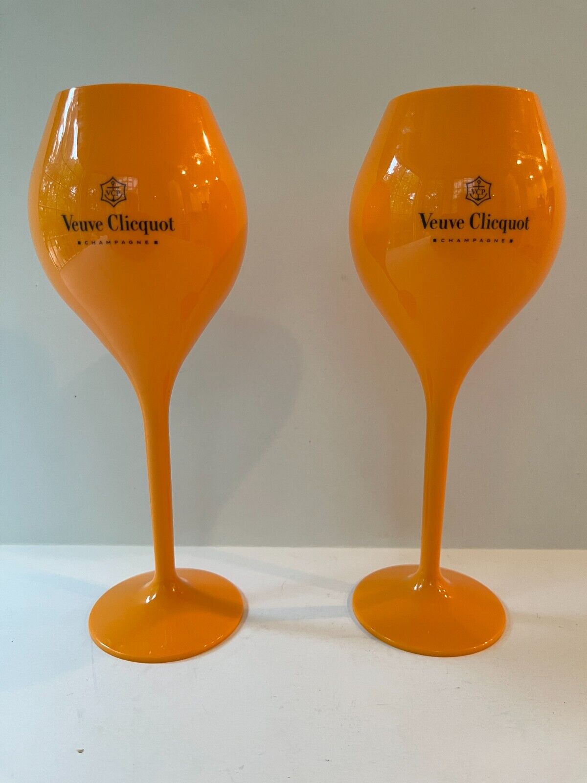 Pair of VEUVE CLICQUOT Champagne Orange Lightweight Acrylic Champagne Glasses