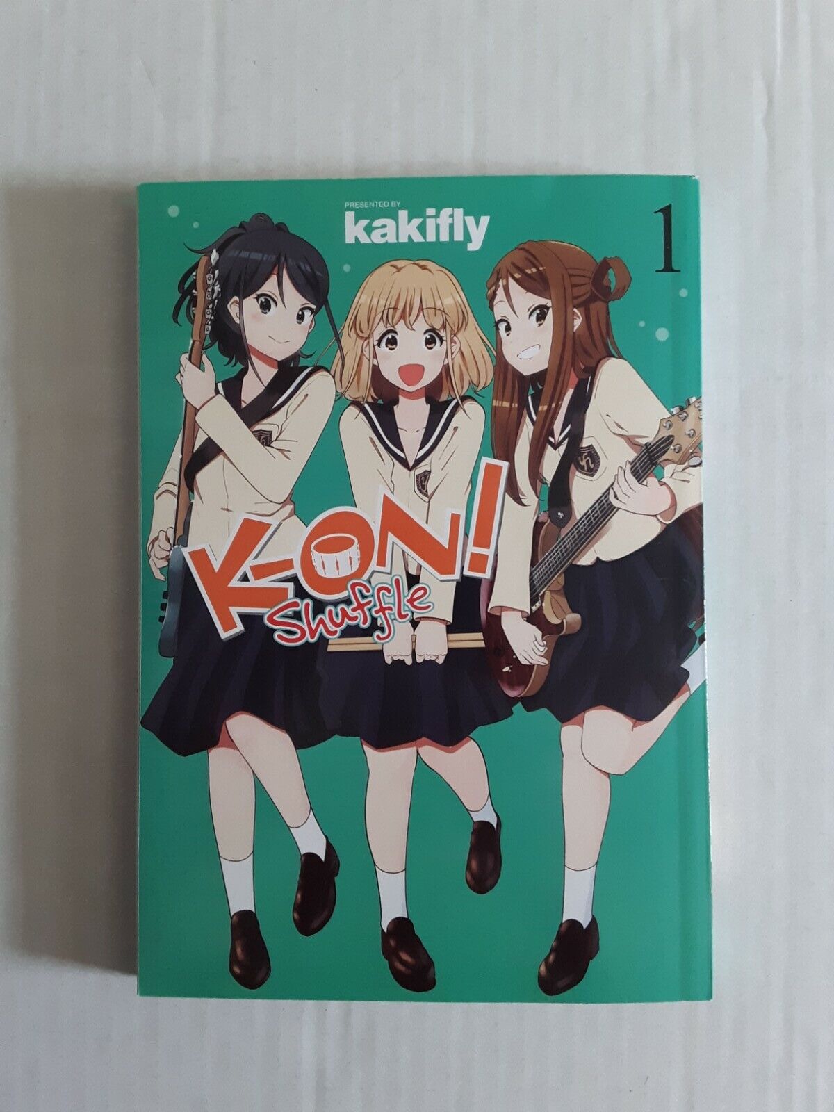 K-ON Shuffle, Vol. 1 (K-ON Shuffle, 1) Paperback – 2023 by kakifly Manga