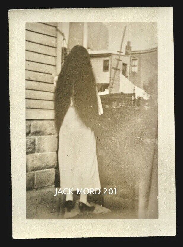creepy unusual old snapshot photo long black hair girl turned away from camera