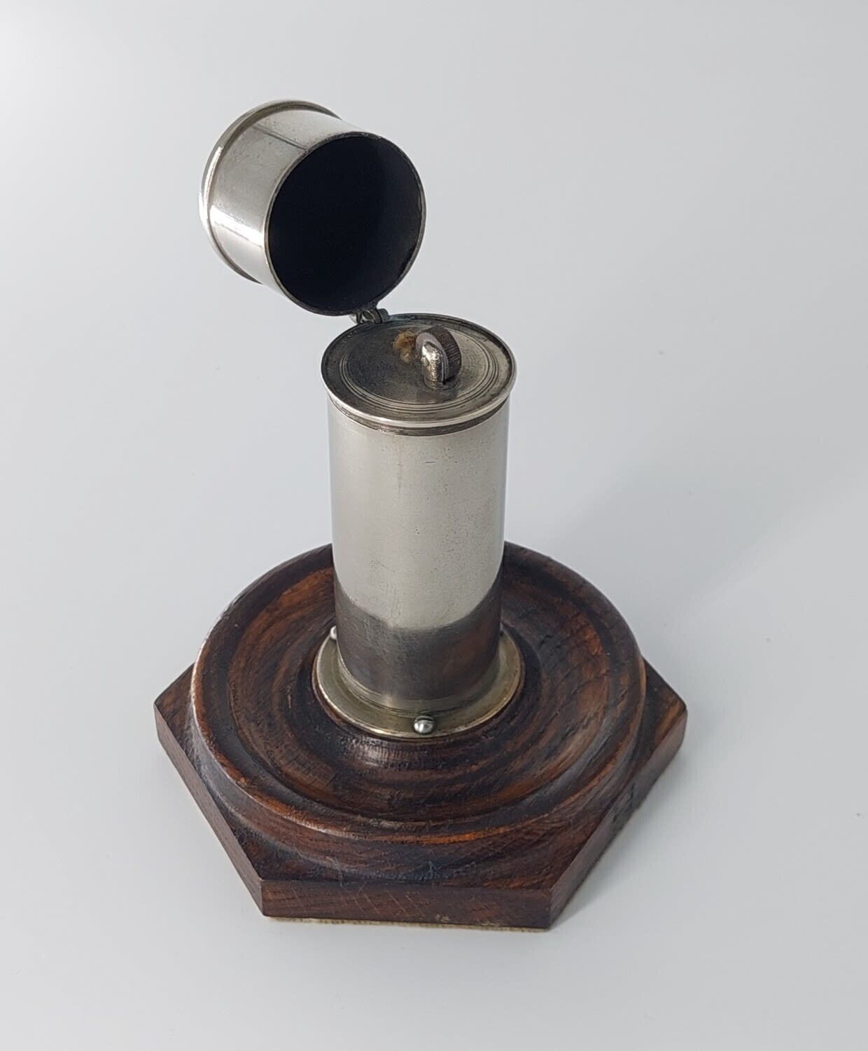 An Antique Oil Lighter With Wood Stand